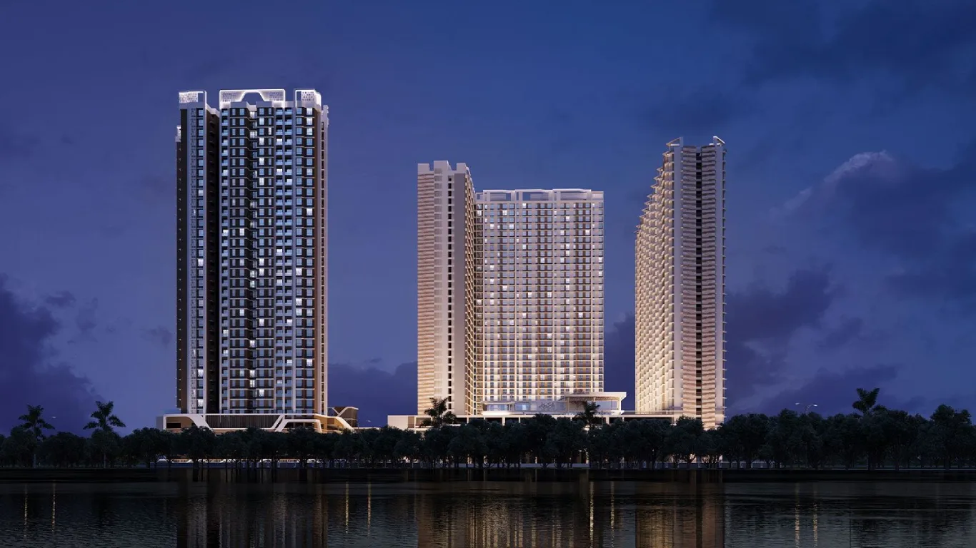 The image displays Dosti West County’s impressive facade with residential buildings lit up beautifully against the evening sky, reflecting the upscale lifestyle in Thane Balkum.